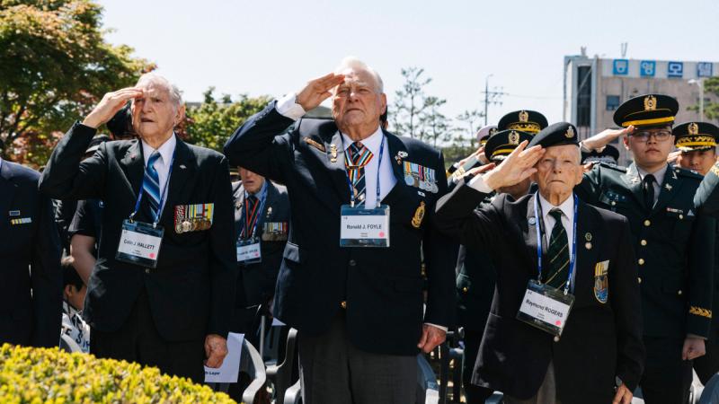 Army veterans salute at a remembrance ceremony in Korea.