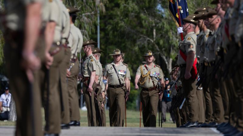Army leadership inspects soldier on ceremony.