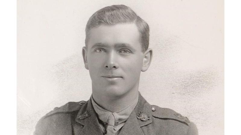 A black and white photo of a man in uniform.