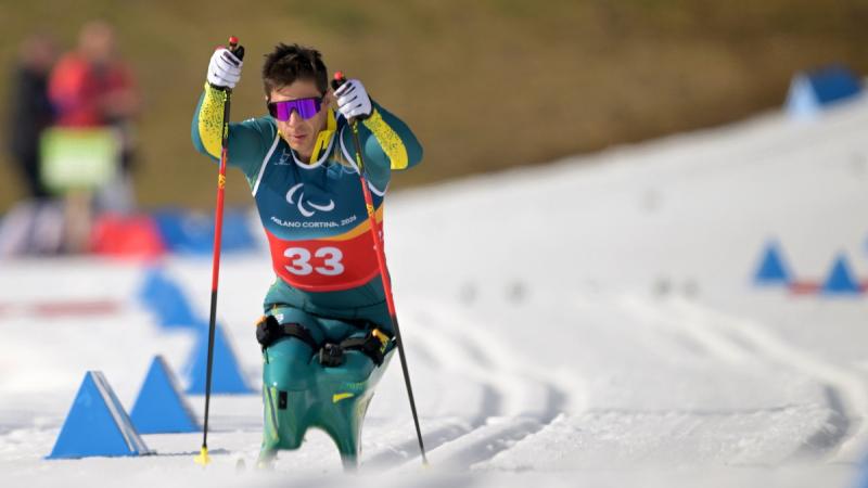 A man on skis descends a snowy slope.