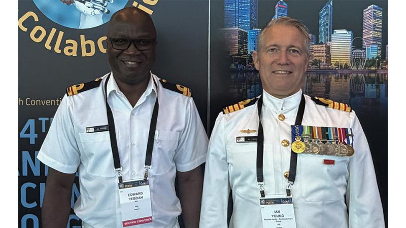 Two military personnel with name tags stand beside each other.