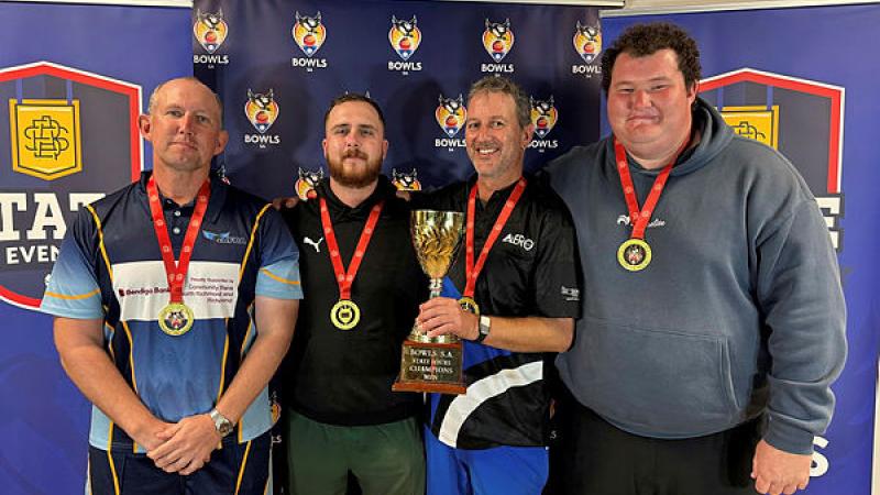Members of the title-winning Salisbury–Modbury team proudly display the Bowls South Australia State Fours trophy and medals.