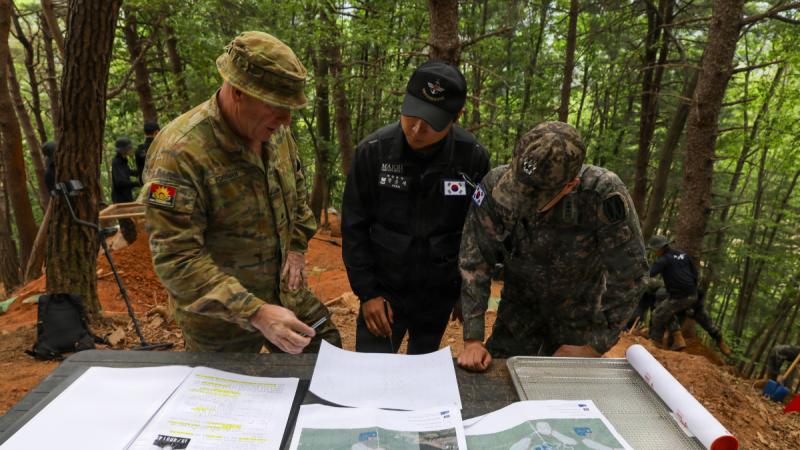 South Korean and Australian soldiers map out the excavation plans during the search