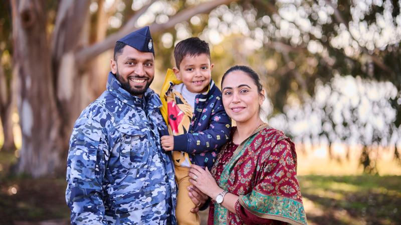 A man in Air Force uniform stands with a woman and a young boy.