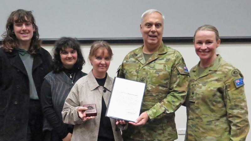 Chief of Joint Capabilities, LTGEN Susan Coyle stands beside WO2 Raymond Waghorn and his family, in a group photo holding the presented Federation Star.