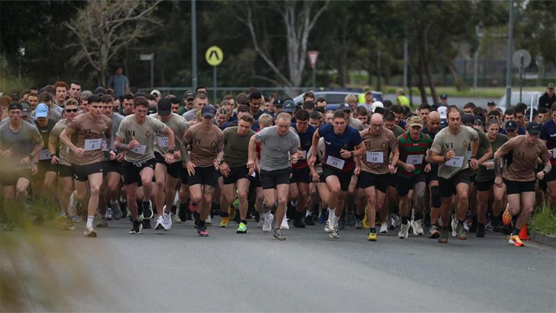 A large group of people start running a race.