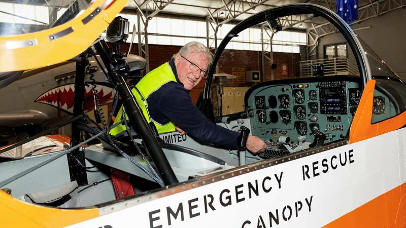 An engineer is working on an Air Force turbo prop plane 