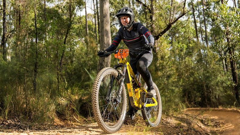 An Army mountain bike riders navigates her way downhill and across country.