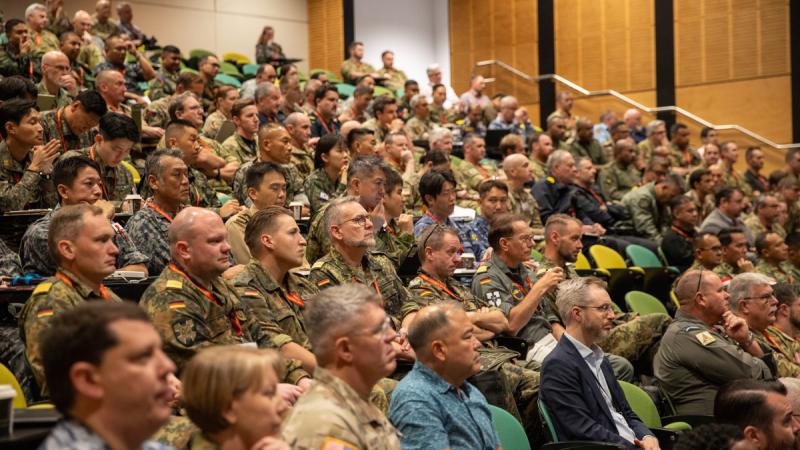 People in uniform fill the seats of an auditorium.
