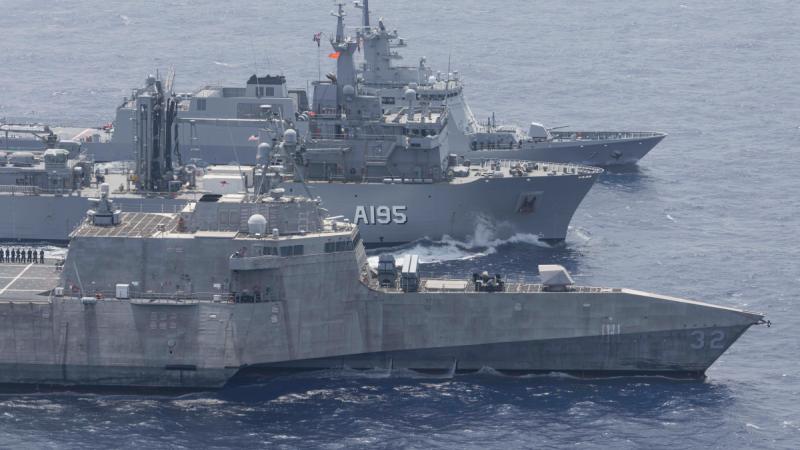 Three ships sit side by side in Philipines.