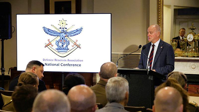 An Army leader stand addressing the audience from his lecturn.